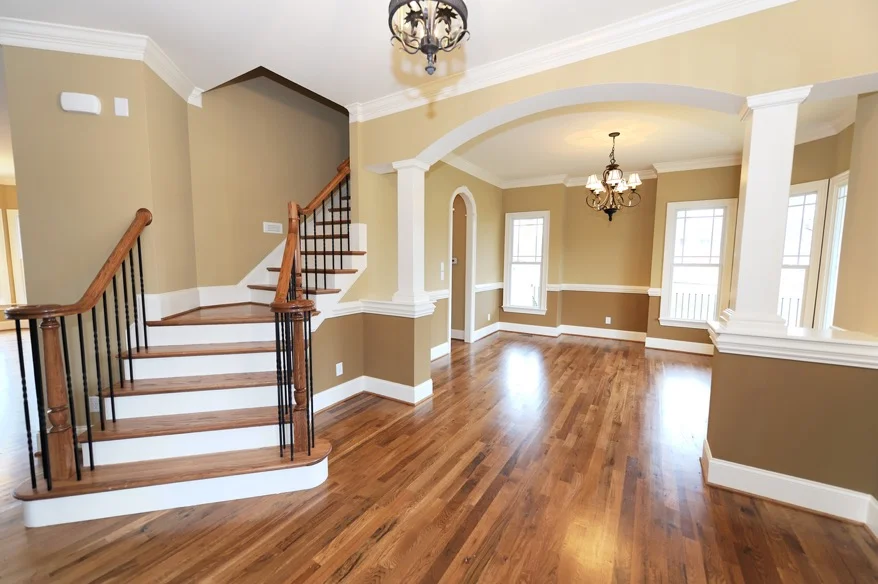 interior of entrance to home in living room and dining room freshly painted with brown and beige